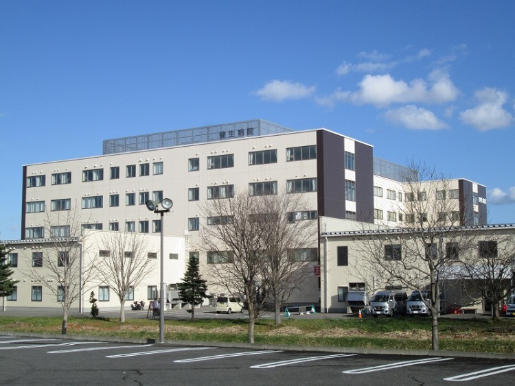 広い駐車場を持つ、大きな建物の健生病院です。
