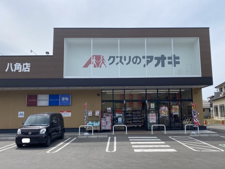 ブラウンの看板が特徴的なクスリのアオキ八角店の正面入り口。駐車場には1台の車が停められています